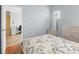 Cozy bedroom with wood-laminate flooring, complemented by a light blue wall and a view into the closet at 437 Bridgewater Court, Kissimmee, FL 34758