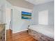 Stylish bedroom with hardwood floors features a rustic bed frame and modern lighting at 437 Bridgewater Court, Kissimmee, FL 34758