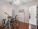 Spare bedroom featuring hardwood floors, bikes, and a doorway to the bathroom at 437 Bridgewater Court, Kissimmee, FL 34758