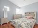 Bright bedroom with hardwood floors, features natural lighting and a decorative bedspread at 437 Bridgewater Court, Kissimmee, FL 34758