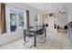 Bright dining area with tile flooring, large windows, and access to the patio at 437 Bridgewater Court, Kissimmee, FL 34758