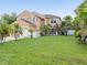 Two-story house with a lush green lawn and many palm trees at 437 Bridgewater Court, Kissimmee, FL 34758