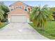 Inviting two-story home featuring a neutral stucco exterior and attached two-car garage at 437 Bridgewater Court, Kissimmee, FL 34758