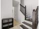 Hallway featuring tiled floors, access to a stairway with wooden handrail and a nearby closet at 437 Bridgewater Court, Kissimmee, FL 34758