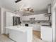 Modern kitchen featuring white cabinets, stainless steel appliances, an island and marble backsplash at 437 Bridgewater Court, Kissimmee, FL 34758
