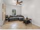 Cozy living room with tile floors and a neutral colored sectional sofa at 437 Bridgewater Court, Kissimmee, FL 34758
