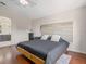 Charming bedroom features a wood-accent headboard, hardwood floors, and a view into the main bathroom at 437 Bridgewater Court, Kissimmee, FL 34758