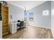 Well-lit home office featuring a large desk, shelves, and a bright window at 437 Bridgewater Court, Kissimmee, FL 34758