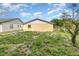 This view of a backyard shows the yard with a building in the background at 450 S Buena Vista Ave, Orlando, FL 32835
