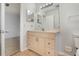 Bathroom featuring a vanity, large mirror, and a toilet in the corner at 450 S Buena Vista Ave, Orlando, FL 32835
