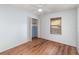 Bright bedroom with wood flooring, ceiling fan, neutral walls, closet and a window at 450 S Buena Vista Ave, Orlando, FL 32835