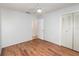Bright bedroom with wood flooring, ceiling fan, neutral walls, closet and a door at 450 S Buena Vista Ave, Orlando, FL 32835