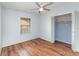 This bedroom features hardwood floors, a ceiling fan, a window, and a closet at 450 S Buena Vista Ave, Orlando, FL 32835