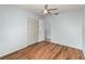 This bedroom features wood floors, a ceiling fan, and a closet for ample storage at 450 S Buena Vista Ave, Orlando, FL 32835