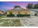 Charming single-story home with a yellow exterior, well-maintained lawn, and inviting entrance at 450 S Buena Vista Ave, Orlando, FL 32835