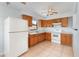 Spacious kitchen with wooden cabinets, white appliances, and tile floors at 450 S Buena Vista Ave, Orlando, FL 32835