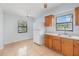 Cozy kitchen featuring wood cabinets, tile floors, and a bright window at 450 S Buena Vista Ave, Orlando, FL 32835