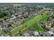 Scenic aerial view shows homes backing onto green spaces and fairways, offering a blend of community and privacy at 468 Jaybee Ave, Davenport, FL 33897