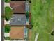 Aerial view displaying the home's roof, pool with screened enclosure, and well-manicured lawn at 468 Jaybee Ave, Davenport, FL 33897