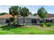 Backyard showing a screened lanai, mature palm trees, and lush landscaping, creating a private outdoor space at 468 Jaybee Ave, Davenport, FL 33897