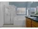 Bathroom features a separate shower, soaking tub with tiled surround, and a bright, natural light at 468 Jaybee Ave, Davenport, FL 33897