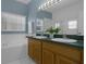 Bright bathroom with double sinks, a soaking tub, and blue accent walls for a relaxing atmosphere at 468 Jaybee Ave, Davenport, FL 33897
