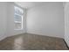 Bright bedroom features a large window and neutral ceramic tile floors at 468 Jaybee Ave, Davenport, FL 33897