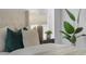 Close up of the primary bed area featuring decorative pillows, headboard and a full size plant at 468 Jaybee Ave, Davenport, FL 33897