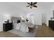 Bright primary bedroom suite with tile floors, ceiling fan and view to a walk in closet at 468 Jaybee Ave, Davenport, FL 33897