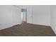 Simple bedroom with laminate flooring, two doors, and plenty of natural light at 468 Jaybee Ave, Davenport, FL 33897