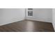 Clean bedroom with sleek, dark wood laminate flooring and a bright window at 468 Jaybee Ave, Davenport, FL 33897