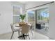 Bright dining area with sliding glass doors and views of the screened-in patio at 468 Jaybee Ave, Davenport, FL 33897