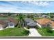 Beautiful home showcasing lush lawn, mature trees, and landscaping, highlighting curb appeal in a tranquil neighborhood at 468 Jaybee Ave, Davenport, FL 33897