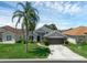 Charming one-story home boasts a manicured lawn, a two car garage, and beautiful landscaping at 468 Jaybee Ave, Davenport, FL 33897