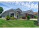 Charming one-story home boasts a manicured lawn, a two car garage, and beautiful landscaping at 468 Jaybee Ave, Davenport, FL 33897