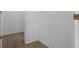 Image of a hallway with white walls and view to a separate tiled room at 468 Jaybee Ave, Davenport, FL 33897