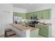 Modern kitchen featuring stainless appliances, bright cabinets, and breakfast bar seating at 468 Jaybee Ave, Davenport, FL 33897