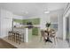 Bright kitchen with stainless appliances, modern cabinets and a cozy breakfast nook overlooking the patio at 468 Jaybee Ave, Davenport, FL 33897