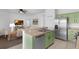 Updated kitchen featuring bright green cabinets, stainless steel appliances, and an open design at 468 Jaybee Ave, Davenport, FL 33897
