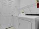 Functional laundry room featuring a washer, dryer, shelving, and a utility door at 468 Jaybee Ave, Davenport, FL 33897