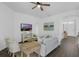 Bright living room with ceiling fan, modern furniture, wood look flooring and neutral decor at 468 Jaybee Ave, Davenport, FL 33897