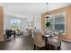 Open concept living and dining room featuring plenty of natural light and laminate flooring at 468 Jaybee Ave, Davenport, FL 33897