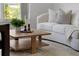 Cozy living room showcasing a modern couch, wood table, stylish decor, and natural light at 468 Jaybee Ave, Davenport, FL 33897