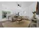 Open-concept living area with seamless flow to kitchen, stylish furnishings, and ample natural light at 468 Jaybee Ave, Davenport, FL 33897