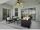 Comfortable screened-in patio seating area with sliding glass doors, offering relaxing outdoor space at 468 Jaybee Ave, Davenport, FL 33897