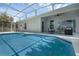Relaxing pool area with a screened-in enclosure, sliding doors, and comfortable outdoor seating at 468 Jaybee Ave, Davenport, FL 33897