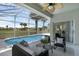 Inviting screened-in pool with a ceiling fan and cozy outdoor seating area at 468 Jaybee Ave, Davenport, FL 33897