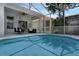 Clear view of the enticing pool, including steps, screened-in enclosure, and outdoor seating area at 468 Jaybee Ave, Davenport, FL 33897