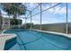 Clear shot of the serene pool area with its blue water and the surrounding screened-in enclosure at 468 Jaybee Ave, Davenport, FL 33897