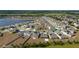 An aerial view of the neighborhood showcases attractive single-Gathering homes around a pond at 4990 Four Strand Ct, St Cloud, FL 34769